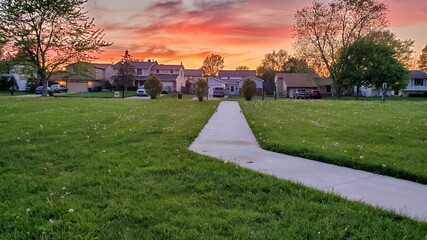 Suburban neighborhood and park at colorful dusk