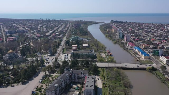 View from drone of modern landscape of Georgian port city of Poti overlooking residential areas and Orthodox Cathedral in Neo-Byzantine style on sunny spring day, Samegrelo-Zemo Svaneti region 
