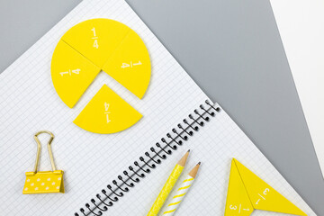 Colorful fractions in mathematics on the open notepad. Interesting math for kids. Education, back...