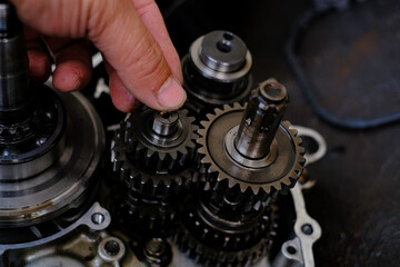 Assemble the motorcycle engine gear by a maintenance technician and check it.	