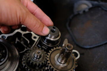 Assemble the motorcycle engine gear by a maintenance technician and check it.	