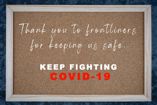 Thank you to frontliners message written on wooden board. Covid-19 