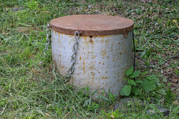 Caisson with a metal lid on a chain close-up