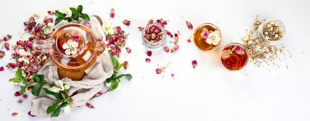 Rose tea with cups and teapot on light gray backround.