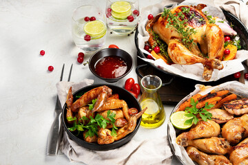 Assorted grilled chicken meat and sauce on gray background. Homemade food concept.