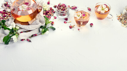 Fototapeta na wymiar Rose tea with cups and teapot on light gray backround.