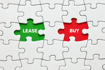 Missing puzzle pieces with the words lease and buy. Decision or dilemma between to lease or to buy.