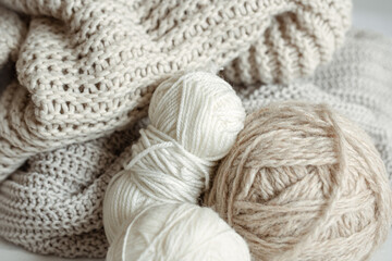 Cozy composition with knitted yarn in pastel colors.
