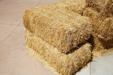 Hay Bales.  Piled stacks of dry straw collected for animal feed. Dry baled hay bales stack. Hay Bales piled up for Seating and baracades. © mike ledray