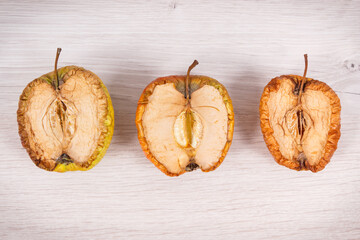 Old moldy apple, unhealthy and disgusting fruit