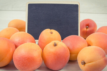 Apricot or peach as healthy snack or dessert. Food containing vitamins and minerals. Place for inscription