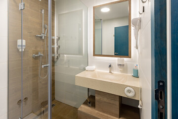 Interior of a modern hotel bathroom with a shower cabin