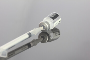 Vaccine vial with needle and syringe