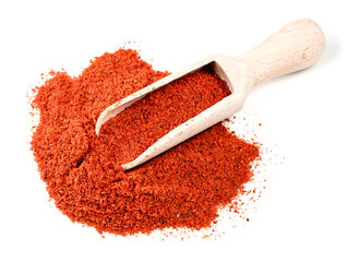 wooden scoop on pile of paprika powder on white