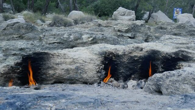Burning fires from vents in rocks-inspiration for the fire breathing Chimaera monster. Natural gas flames burning at Yanartas, Cirali, Olympos, Turkey