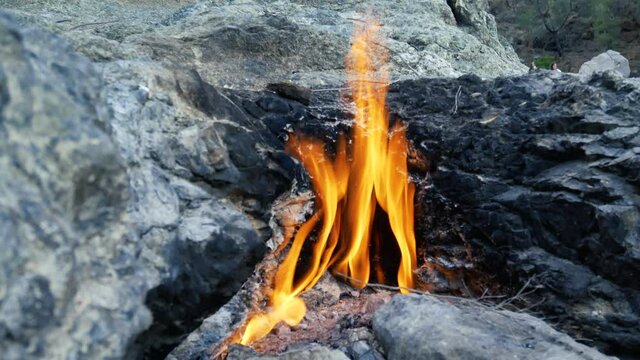 Yanartas or flaming stone-geographical feature near Olympos. Natural gas flames burning at Chimera, Cirali, Turkey