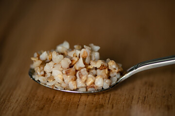Boiled buckwheat in a spoon 