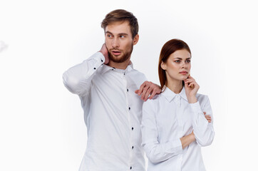 man and woman in white shirts are standing next to each other smile communication family