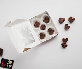 Milk chocolate pieces isolated on white background from top view