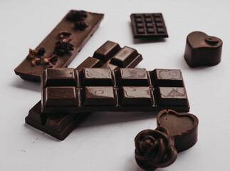 Milk chocolate pieces isolated on white background from top view