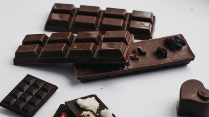 Milk chocolate pieces isolated on white background from top view