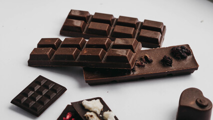 Milk chocolate pieces isolated on white background from top view