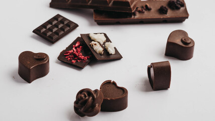 Milk chocolate pieces isolated on white background from top view