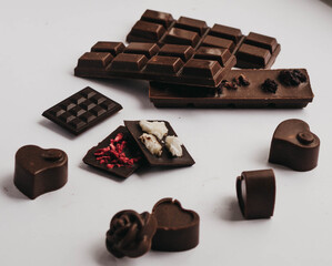 Milk chocolate pieces isolated on white background from top view