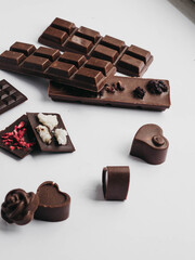 Milk chocolate pieces isolated on white background from top view