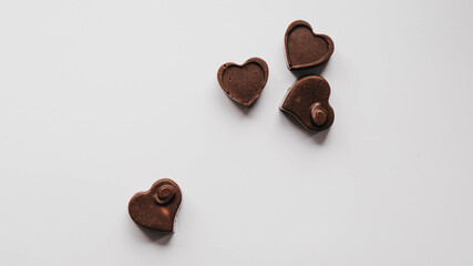 Milk chocolate pieces isolated on white background from top view