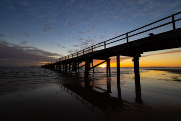 Fototapeta na wymiar Sunset at wooden and historic One Mile Jetty in Carnarvon, Western Australia