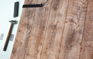 Laying laminate flooring on the loggia. The laminate laying tool lies on top of the installed laminate in the room.