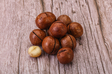 Brown macadamia nut heap over background