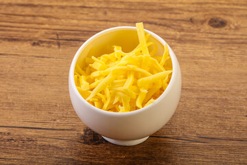 Shredded yellow cheese in the bowl