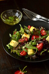 Leaf salad with strawberries, cheese and seed, vertical