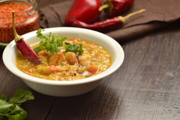 Dal, red lentil soup with turmeric, garlic, chili and cilantro. Indian food.