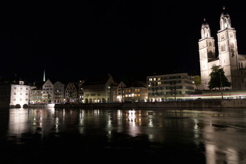 Fototapeta premium Old town of Zurich at night with church Grossmünster (great minster) with river Limmat. Photo taken May 29th, 2021, Zurich, Switzerland.