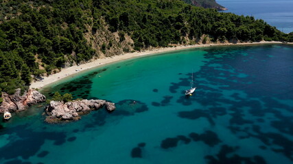 Fototapeta premium Drone aerial view of tourists enjoying a paradise luxury Yacht trip around Skopelos island, Greece, Aegean Sea, Europe.