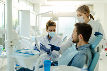 Doctor talking with her patient and teaching a radiograph.
