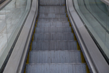 Steps of the escalator close-up . Escalator stairs to an underground subway station .