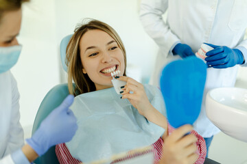 Dentist curing a woman patient in the dental office in a pleasant environment.