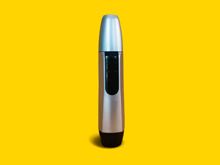 Closed Nose Trimmer isolated on yellow background. Front side standing position. Black and silver color.
