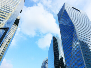 Huge skyscrapers with glass facades against the blue sky. Business center, offices of international corporations, business lifestyle. - 436445532