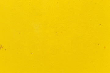 Old iron door painted in bright yellow close-up, for design