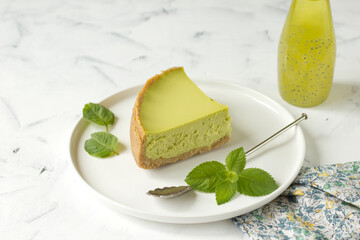 Lemon cheesecake  slice, slice of tasty cake on white plate served with dessert fork