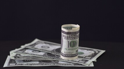American dollars. Banknotes. 1000 dollars. Benefit. Money on a black background. Securities. Taxes. Dividends. Sale. The cost of goods. Money machine. New money. Old money. Close-up