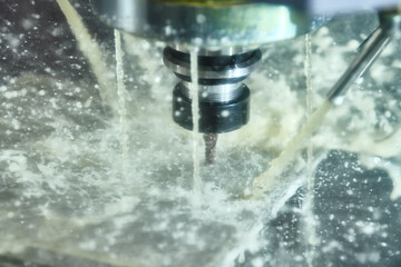 Obraz na płótnie Canvas CNC milling machine work. metal processing with coolant