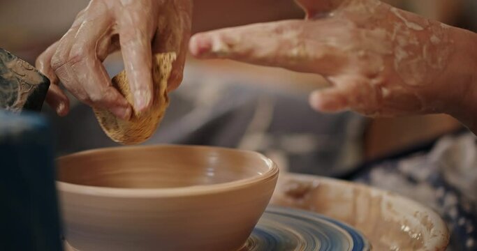Close-up of pottery creating a clay plate shaping clay only hands anonymous frame creativity inspiration hobbies
