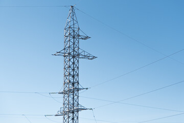 high-voltage power lines against a blue sky