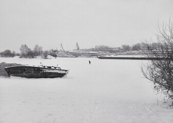 
Anchorage of motor ships and ships in winter on an ice-covered river on the banks of the Kama River in Perm